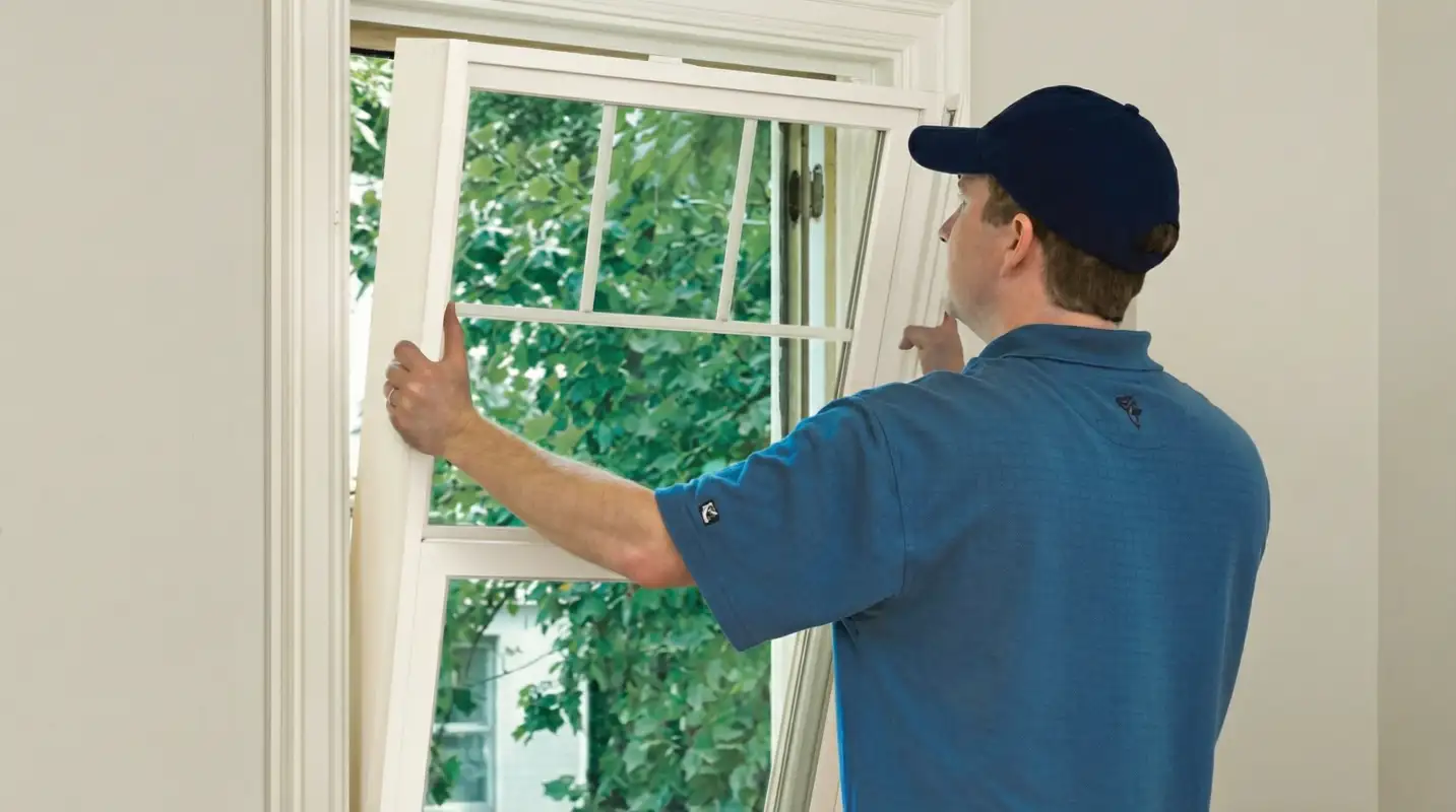 Professional contractors performing a residential window insulation and replacement service in Albany, NY